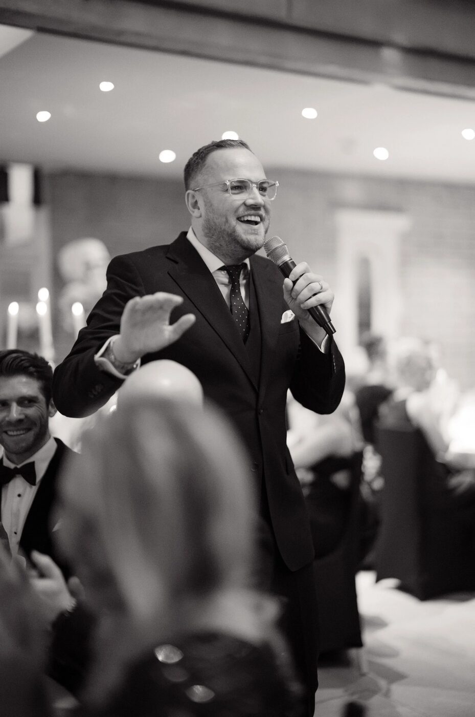 James Sinclair speaking to a room with a microphone
